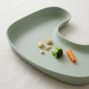 Close-up of the wipe-clean food catcher tray holding baby food